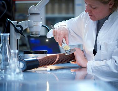 Researcher examining cable sample