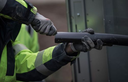 Cable worker removing sheath from medium voltage cable