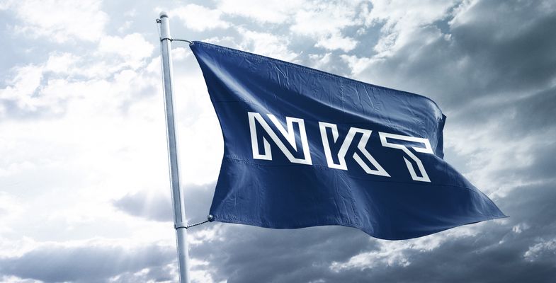 NKT flaf flying in the wind with grey sky