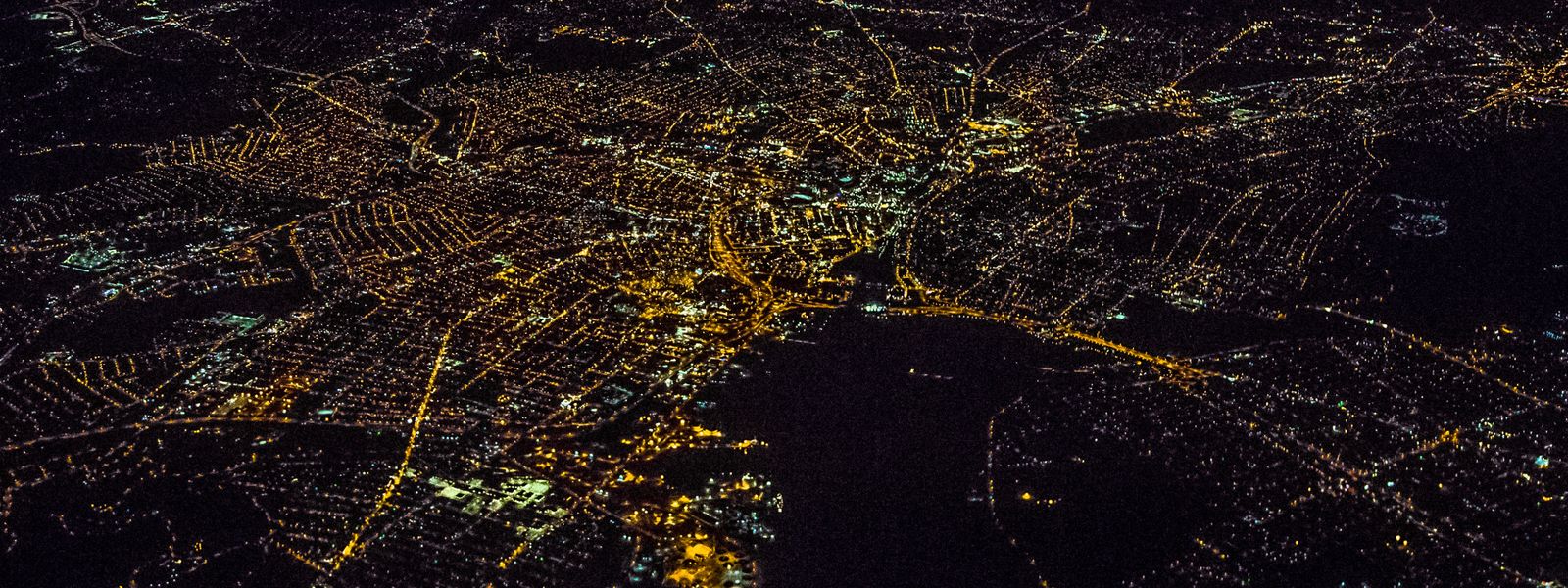 Bird's eye view of a city at night with lights shining