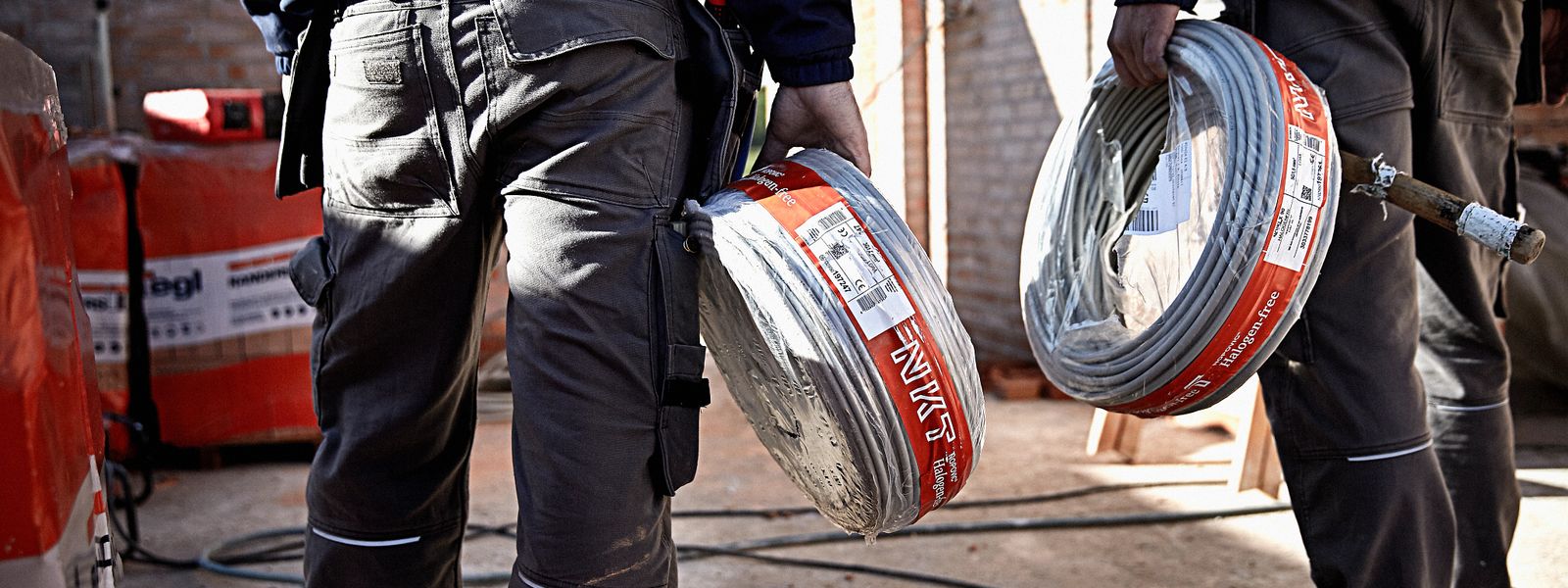 Construction worker holding NKT low voltage cables